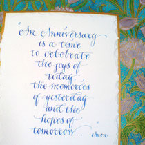 close up of a paper anniversary gift in copperplate script with an illuminated william morris frame