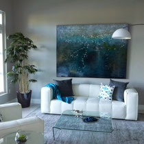 design project by Mia Home Trends featuring a staged modern living room with white sofa, white chair, glass coffee table and blue and gray accents