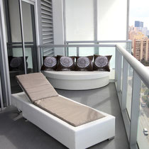 interior design project by Mia Home Trends featuring a staged modern balcony with white sun lounge and round day bed
