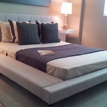 interior design project by Mia Home Trends featuring a staged bedroom with gray upholstered platform bed