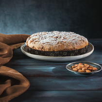 Schiacciata traditional soft flat cake covered with amaretto frosting, sliced almonds and icing sugar (500g)