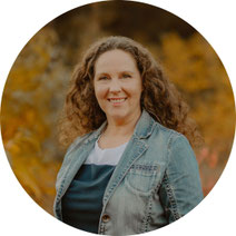 Susanne Kruse lächelt in herbstlicher Natur – verkörpert Ruhe, Klarheit und die Frequenzarbeit, die hinter Reality Reset steht.