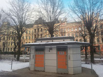 Public toilet in central Riga with historic apartment building in background