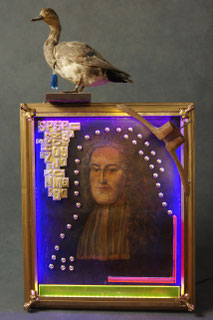 Assemblage light art sculpture consisting of an early 19th century painting, a portrait of a Frenchman.  It includes brass letters, brass buttons, plexiglas, antique hanger, and taxidermed duck at the top. It is illuminated with LEDs from 4 sides.