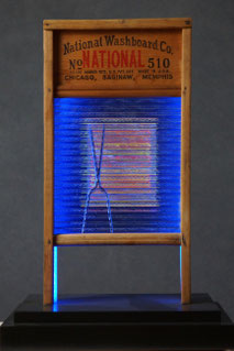 Assemblage light art sculpture made from an old glass washboard. This sculpture acts almost as a "light painting" with plexiglass, lenticular plastic, and LEDs placed in back.  The glass which refracts the light and the appearance of these components.