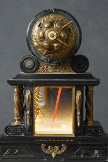 Assemblage light art sculpture which incorporates two visual focal points. At the top is a clock with an Art Nouveau face. At the bottom is an infinity mirror with glass beads and LEDs. The structure which holds the two together was a marble clock.