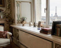 Holzfensterbank weiß oder farbig lackiert aus Buche -die Einrichtung ist im Jugendstil angelehnt mit altmodischen Sitzmöbeln; das Fenster zeigt einen Blick auf die skyline von Paris