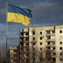 A Ukrainian national flag near buildings destroyed by a Russian attack in the town of Borodyanka near Kyiv, 16 Feb. 2023