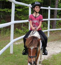 Girl is enjoying her riding lesson 