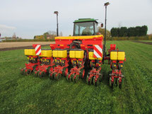 A precision seed drill at work in a clover living mulch.