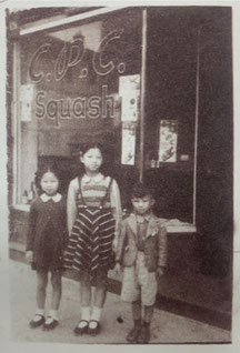 The only known photo of the C.P.C. coffee shop on Bubbling Well Road: Yamei, Yaqing and Xiangxing Zhang standing in front of their father's Café in 1945 (provided by Charles Zhang)