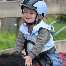 Tiny tot rider is learning the basics about horseback riding
