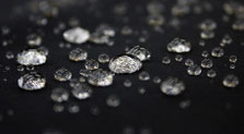 Water droplets on water-repellent fabric demonstrating resistance to moisture.