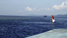 eva marie lobmaier, boundforeden, travel website, southeast asia, photographs, indonesian flag, indonesia, boat, ocean,