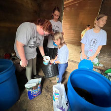 girls preparing the grain/feed for the horse/pony