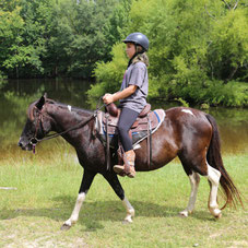 Girl on a trail ride by the ponds