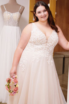 Beautiful model showcasing an elegant plus-size evening gown with a flattering fit for formal events.