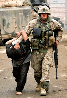 A U.S. Marine leads away a captured Iraqi man in Fallujah, Iraq, in 2004. Anja Niedringhaus. Anja Niedringhaus/Associated Press