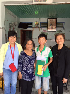 Nam Khang and his grandmother, in front of the snack shop