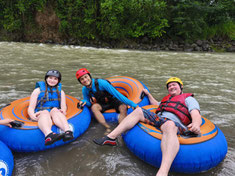 Family tubing adventure on the crystal-clear waters of Arenal River.