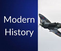 Two tanks drive through a desert under a blazing sun, next to bold text reading “Modern History” on a dark blue background.