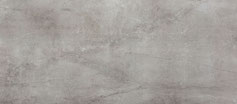 Dekton Soke, évoquant la matière brute du béton. Son gris anthracite et sa texture à l'effet béton ciré apportent une touche industrielle et contemporaine à tout intérieur.