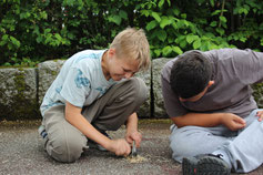 Teilnehmende lernen Feuer machen – erlebnispädagogische Aktivität in der Natur für Ferienlager, Klassenlager und Jugendgruppen
