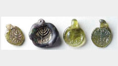 Four late Roman ancient stamped glass pendants with seven armed menorah