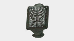 An ancient early Jewish bronze finger ring, engraved with a menorah on a tripod base, 4th-5th century
