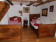 Gästezimmer. Guest room furnished with antiques, but convenient beds with new mattresses.