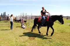 Emmy taking her first calf to the fire. Howard's in the pen on Buster.