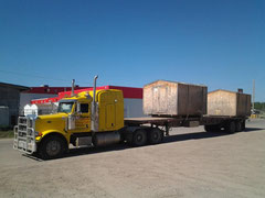 Semi truck loaded with sheds