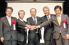 「天の川ネット」での交流を確認し、握手する(左から)小沢昌記奥州市長、向原翼薩摩川内市副市長、林台長、森下一男小笠原村長、中山義隆石垣市長