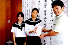 ヨットで台湾を訪れる堀井さん、三上さん(左から)に中山市長が親書を託した=31日午後、市役所