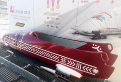 Red bobsleigh with white Latvian ethnographic symbols at Sigulda bobsleigh track