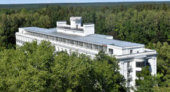 Aerial shot of white Kemeri Sanatorium building surrounded by green forest