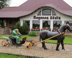 Raganas Ķēkis bistor in Ragana village, central Latvia, with a sculpture of a witch in a horse drawn cart in the foreground