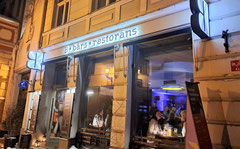 Neon lit facade of B Bārs bar in Riga's Old Town