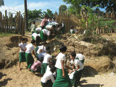 Children cleaning the school grounds