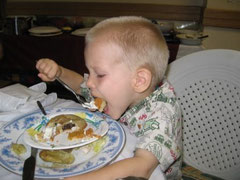 Elijah taking half of his pumpkin pie in one bite