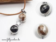 KA 8: Zwei befüllte Glasperlen in 16mm Grösse, dazwischen ein Hämatitherzchen, oben eine  Öse zum anbringen von Bändern oder Ketten. Preis: 38 Euro ( Band oder Kette auf Anfrage)