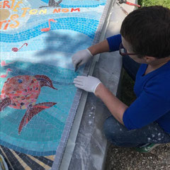 Artiste mosaïste Toone Nicol installant une décoration pour tombale sur-mesure au cimetière de Chennevières-sur-Marne