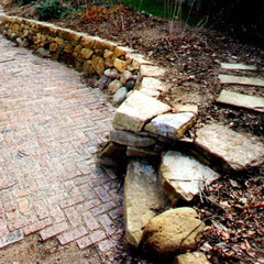 Dry stone retaining wall, private garden, Kent, OH utilizing a mixture of native granite and sandstone.