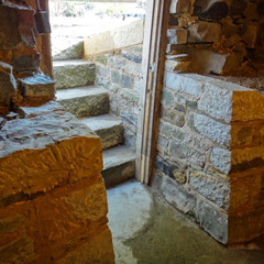 Cellar entry cheekwalls complete.  Recycled, load-bearing sandstone walls to match existing stone foundation.