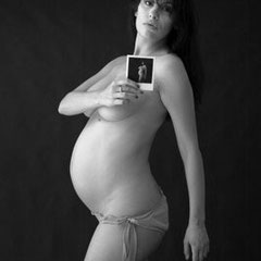 Ritratto di maternità di Raffaella con tecnica mise en abyme: il soggetto tiene una Polaroid di se stessa, fotografia fine art di Alessandro Tintori.