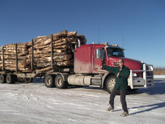 Kelly in front of her rig. Hauling a load of logs with the Mack truck.