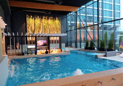 Swimming pool and bar with large glass wall at Hotel Jurmala Spa