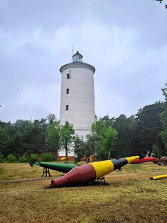 White lighthouse at Oviši with coloured bouys in front in Kurzeme, Latvia