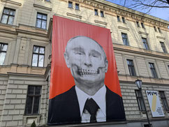 Large grotesque caricature of Vladimir Putin on a building opposite the Russian Embassy in Riga