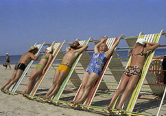 1970s colour photo of people in swimwear reclining almost vertically on sun beds in Jurmala, Latvia